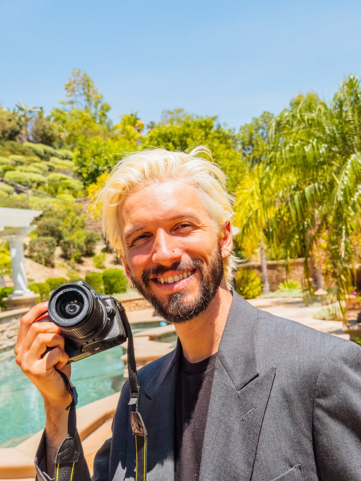 Mark Krizsan holding a camera outdoors